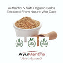 Bowl of brown powder with a wooden scoop, labeled 'Authentic & Safe Organic Herbs Extracted From Nature With Care' by AyuMantra.