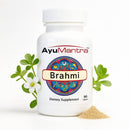 AyuMantra Brahmi dietary supplement bottle with Brahmi leaves and powder on a white background.