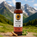 Bottle of Brimhana Organic Ayurvedic Oil with mountains in the background