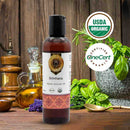 Bottle of Brimhana Organic Ayurvedic Oil with USDA Organic and OneCert logos on a wooden background.
