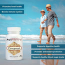 AyuMantra cinnamon capsules with senior couple walking on the beach and health benefits text.