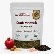 AyuMantra Dadimastak Powder packaging with pomegranate, nuts, and pepper on a white background