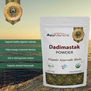AyuMantra Dadimastak Powder packaging with product details on a scenic background