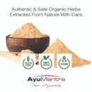 Ayurvedic herbs with a wooden bowl and packaging, featuring AyuMantra branding.