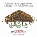 Pile of organic herbs with AyuMantra branding and certification logos on a white background