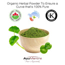 Bowl of green herbal powder with leaves, featuring certification logos and AyuMantra branding.