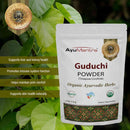 AyuMantra Guduchi Powder packaging with green leaves in the background