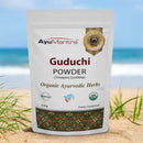 AyuMantra Guduchi Powder package on a beach with ocean view