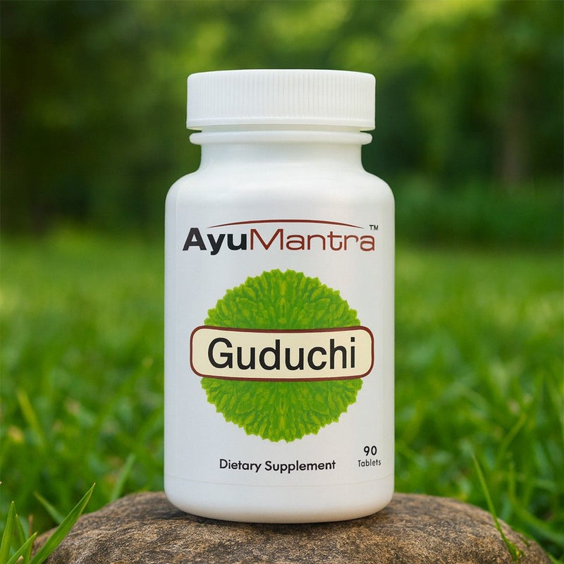 AyuMantra Guduchi dietary supplement bottle on a natural background.