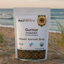 AyuMantra Gurmar Powder package on a beach