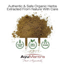 Herbal powder with AyuMantra branding and certification logos on a white background