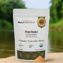 AyuMantra Haritaki Powder packaging with a natural background