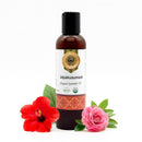 Bottle of Japakusumadi organic ayurvedic oil with flowers on a white background