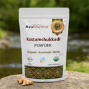 AyuMantra Kottamchukkadi Powder packaging with herbs on a natural background