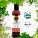 Bottle of Krishna Kuntal organic ayurvedic oil with green leaves and certification logos on a white background