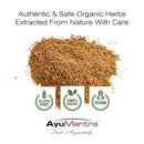 Brown powder with AyuMantra branding and certification logos on a white background