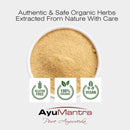 Gold powder in a container with AyuMantra branding and organic certification logos on a white background.