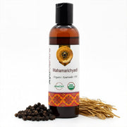 Bottle of Mahamarichyadi Ayurvedic oil with ingredients on a white background