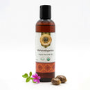 Bottle of Mahavishgarbha organic ayurvedic oil with a decorative label on a white background.