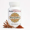AyuMantra Manjistha dietary supplement bottle with roots and powder on a white background