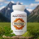 AyuMantra Moringa dietary supplement bottle with a mountainous background