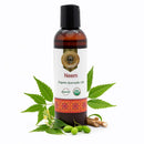 Bottle of Neem organic ayurvedic oil with leaves and seeds on a white background