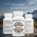 AyuMantra Neem dietary supplement bottles with a mountainous background