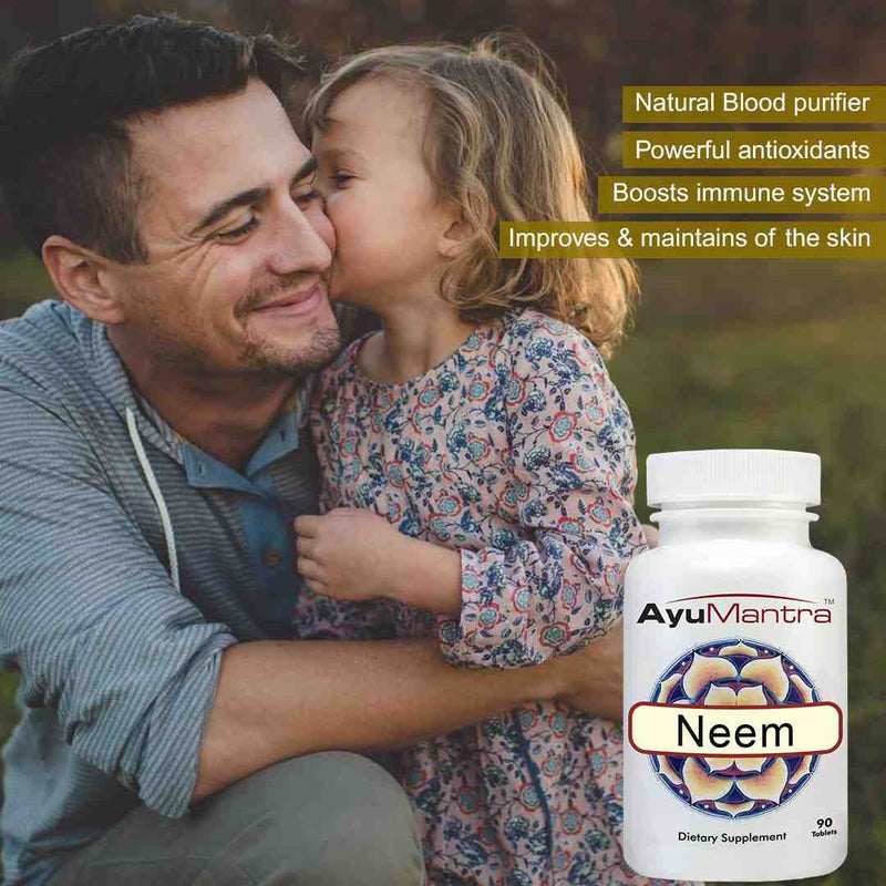 Man and child embracing with AyuMantra Neem supplement bottle in the foreground