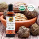 Bottle of Panchaguna Ayurvedic Oil with USDA Organic and OneCert Organic certification logos, surrounded by Ayurvedic药材 on a wooden surface.