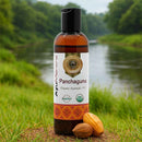 Bottle of Panchaguna Organic Ayurvedic Oil with a natural background