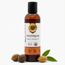 Bottle of Panchaguna Organic Ayurvedic Oil with ingredients on a white background