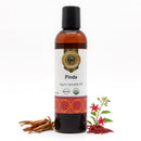 Bottle of Pinda organic ayurvedic oil with a decorative label on a white background.