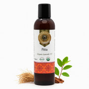 Bottle of Pitta Organic Ayurvedic Oil with a decorative label on a white background