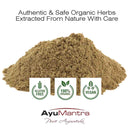 Pile of organic herbs with AyuMantra branding and certification logos on a white background