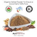 Organic herbal powder in a white bowl with various herbs and spices, featuring certification logos and AyuMantra branding.