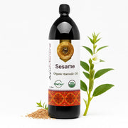 Bottle of Ayurveda sesame oil with sesame seeds and plant on a white background