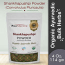 Package of AyuMantra Shankhapushpi Powder with branding and product details on a light background