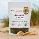 AyuMantra Shatavari Powder packaging on a beach background