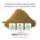 Pile of green powder with AyuMantra branding and certification logos on a white background