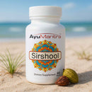 AyuMantra Sirshool Tablets bottle on sandy beach with herbs, Ayurvedic Sirshool Tablets for head comfort.