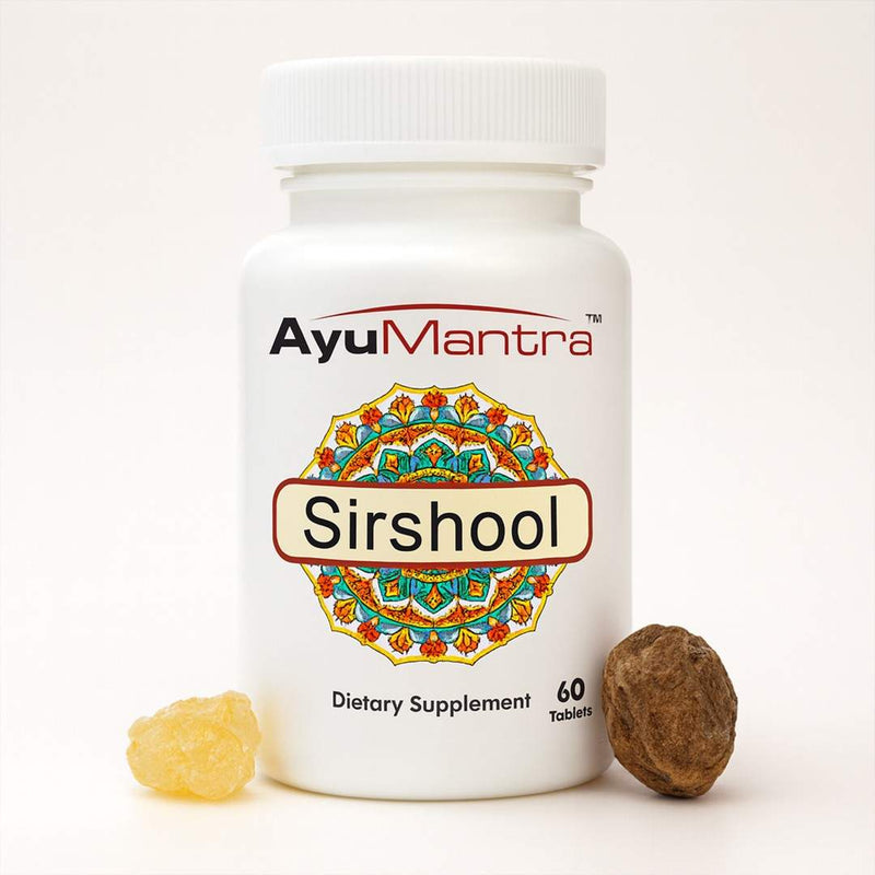 Studio image of AyuMantra Sirshool Tablets bottle with herbal resin and fruit beside it.