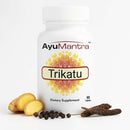 AyuMantra Trikatu tablets bottle on white background with ginger, long pepper and black pepper.
