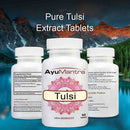 AyuMantra Tulsi extract tablets three-bottle set with supplement facts against a mountain lake backdrop.