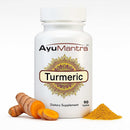 Ayumantra Turmeric tablets bottle with Curcuma longa root slices and bright yellow powder.