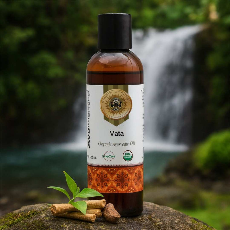 Bottle of 'Vata' organic ayurvedic oil with a natural background