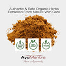 Pile of brown powder with AyuMantra branding and certification logos on a white background