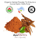 Organic herbal powder with sticks and a leaf, featuring certification logos and AyuMantra branding.