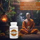 Ayumantra Yoginex tablets bottle beside meditating monk, Ayurvedic supplement for calm mood and mental balance.