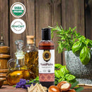 YoniPichu organic ayurvedic oil bottle with USDA Organic and OneCert Organic logos on a wooden background.