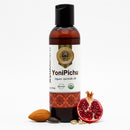 YoniPichu organic ayurvedic oil bottle with pomegranate and almond on a white background